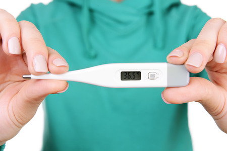 woman holding thermometer close up