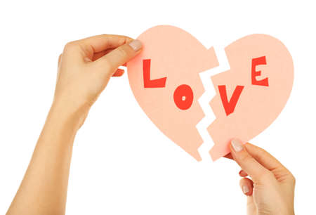 Female hands holding broken heart isolated on whiteの写真素材
