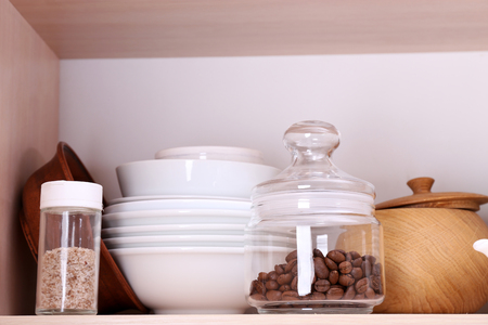 Kitchen utensils and tableware on wooden shelfの写真素材