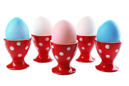 Boiled eggs in holders isolated on whiteの写真素材