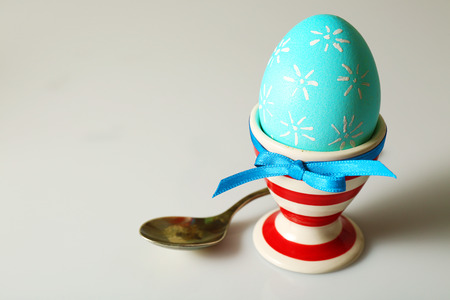 Boiled egg in holder on light background
