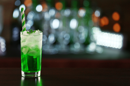 Green cocktail on table on dark backgroundの写真素材