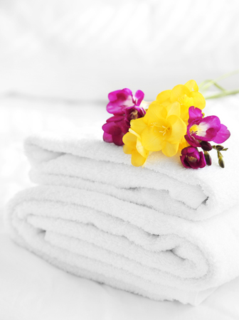 Colorful beautiful freesias on fresh towels in hotel, close upの写真素材