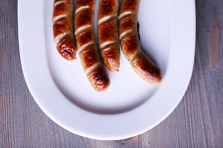 Grilled sausages on plate on table close upの写真素材