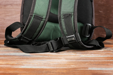 Backpack on wooden background