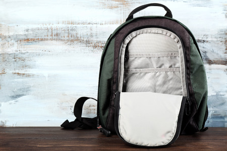 Backpack on wooden background