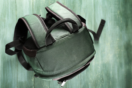 Backpack on wooden background