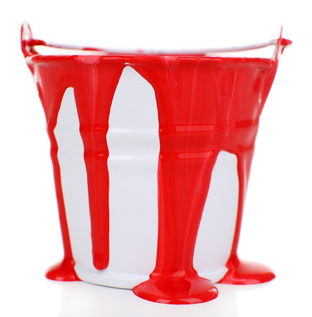 Bucket of red paint isolated on whiteの写真素材