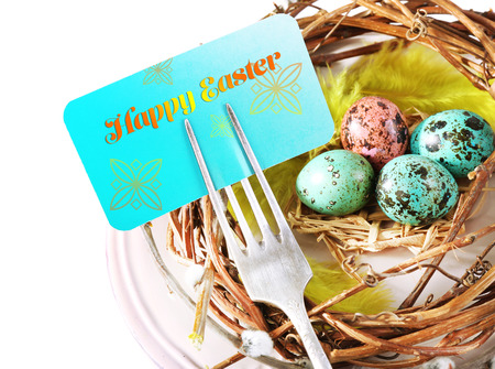 Easter table setting with empty card and Easter eggs, close up