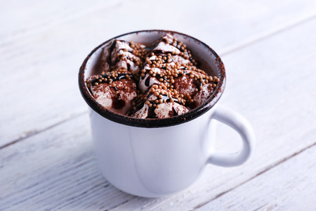 Mug of cocoa with marshmallows on wooden backgroundの写真素材