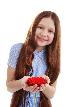 Beautiful little girl with flower, isolated on whiteの写真素材