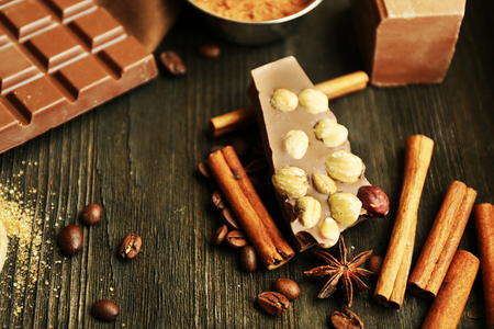 Still life with set of chocolate, nuts and spices on wooden table, closeupの写真素材
