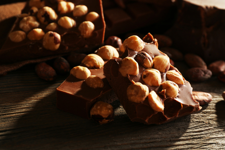 Still life with set of chocolate with nuts on wooden table, closeupの写真素材