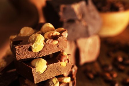 Stack of chocolate with nuts on wooden table, closeupの写真素材