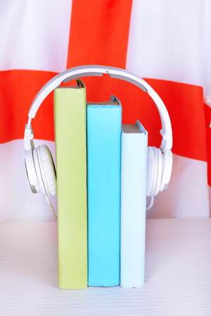 Books and headphones on England flag backgroundの写真素材
