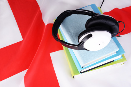 Books and headphones on England flag backgroundの写真素材