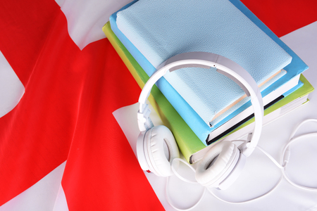 Books and headphones on England flag backgroundの写真素材