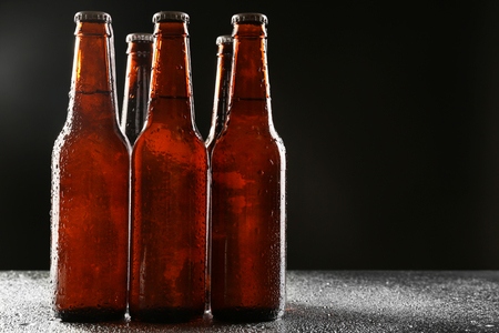 Glass bottles of beer on dark backgroundの写真素材