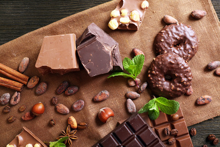 Chocolate with mint, spices and coffee beans on table, closeupの写真素材