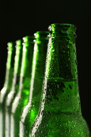 Glass bottles of beer on dark backgroundの写真素材