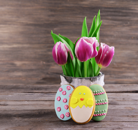 Delicious Easter cookies on table on wooden background
