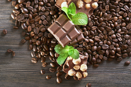 Chocolate with mint and coffee beans on wooden table, closeupの写真素材