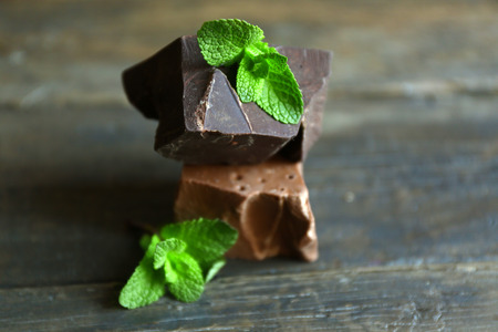 Delicious chocolate with leaves of mint on wooden backgroundの写真素材