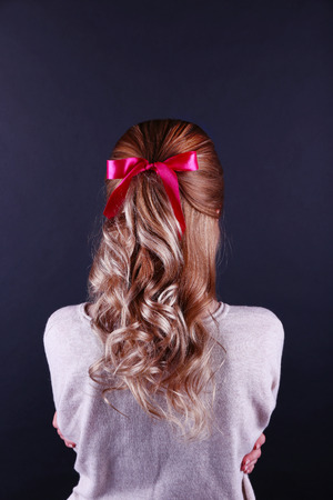 Female hairstyle with color ribbon on dark backgroundの写真素材