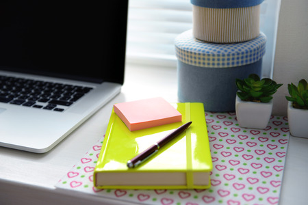 Laptop, notebook on windowsill. Working place conceptの写真素材