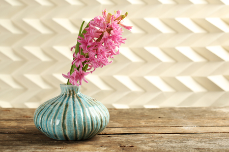 Beautiful hyacinth flower in vase on wooden tableの写真素材