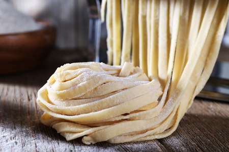 Homemade noodles nest on wooden table, closeupの写真素材