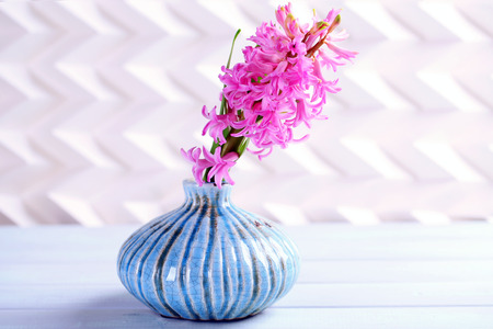 Beautiful hyacinth flower in vase on wooden tableの写真素材