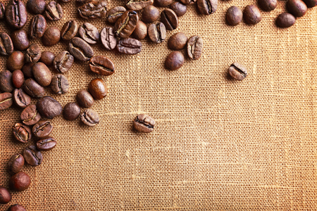 Frame of coffee beans on color sackcloth backgroundの写真素材