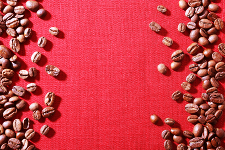 Frame of coffee beans on color sackcloth backgroundの写真素材