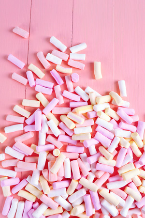 Sweet candies on color wooden backgroundの写真素材
