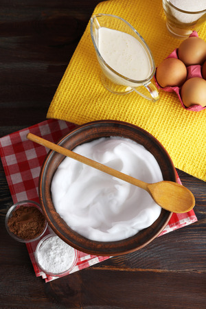 Whipped egg whites and other ingredients for cream on wooden table, top viewの写真素材