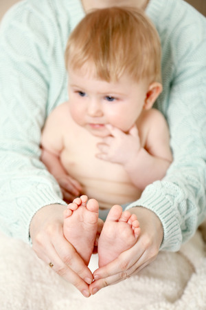 Newborn baby in mother hugs, close-upの写真素材