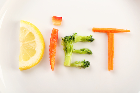 Word DIET made of sliced vegetables on white plate backgroundの写真素材