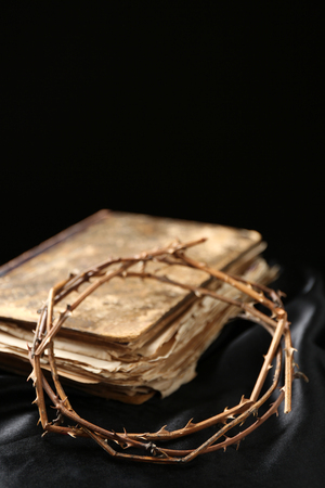 Crown of thorns and old bible on black backgroundの写真素材