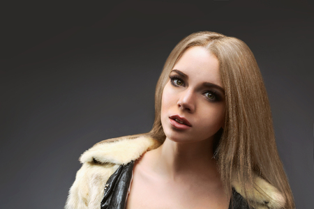 Portrait of beautiful young woman on gray backgroundの写真素材