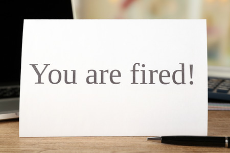 Message You're Fired on wooden table, closeupの写真素材