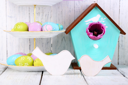Easter decoration, eggs and tulips on table on wooden backgroundの写真素材