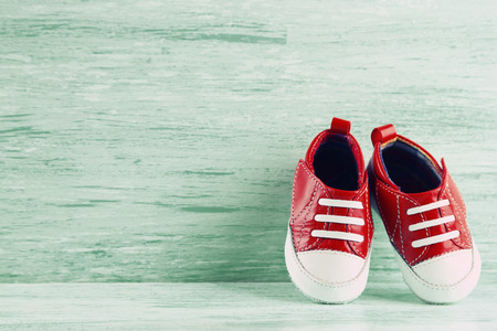 Colorful toddler shoes on wooden backgroundの写真素材