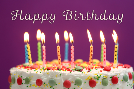 Birthday cake with candles on purple backgroundの写真素材