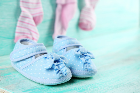 Cute toddler shoes on wooden backgroundの写真素材
