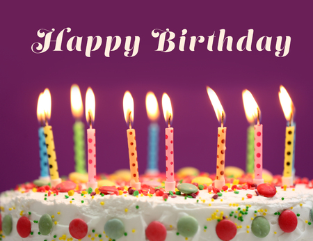 Birthday cake with candles on purple backgroundの写真素材