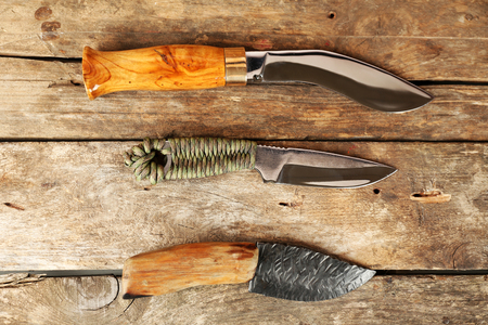 Hunting knives on wooden backgroundの写真素材