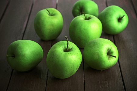 Green apples on wooden table, closeupの写真素材