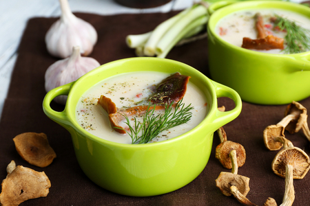Mushroom soup with greens on color napkin, closeupの写真素材