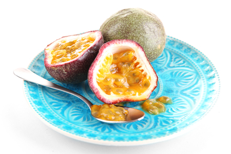 Passion fruit on plate isolated on whiteの写真素材